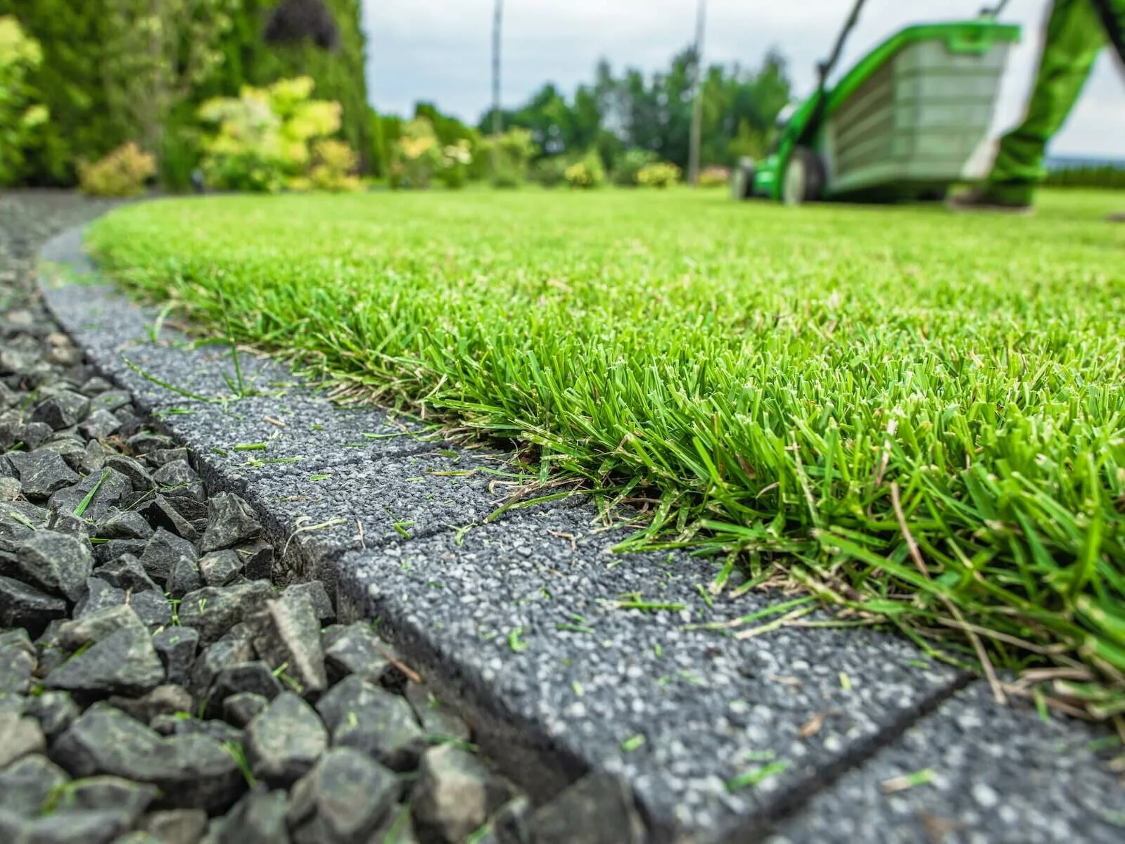 A freshly maintained green lawn with a cleanly edged border