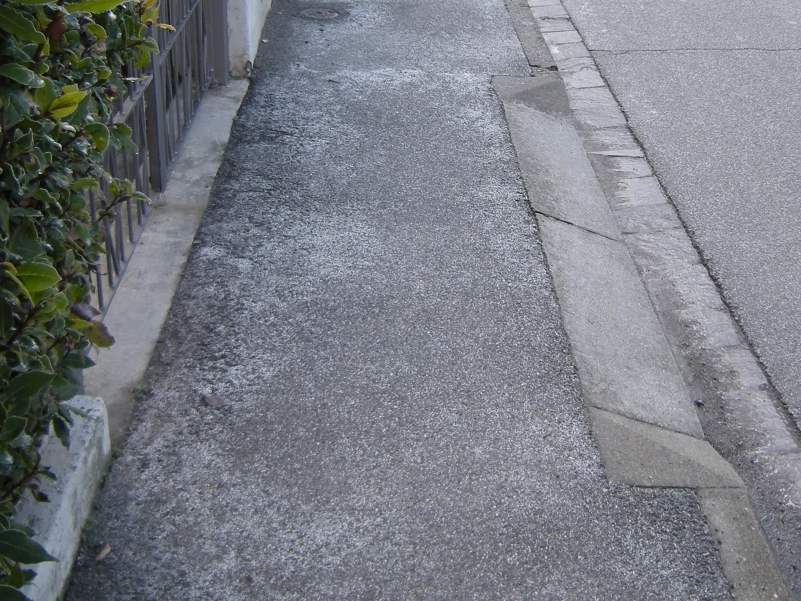 Rock salt spread on a sidewalk for ice control